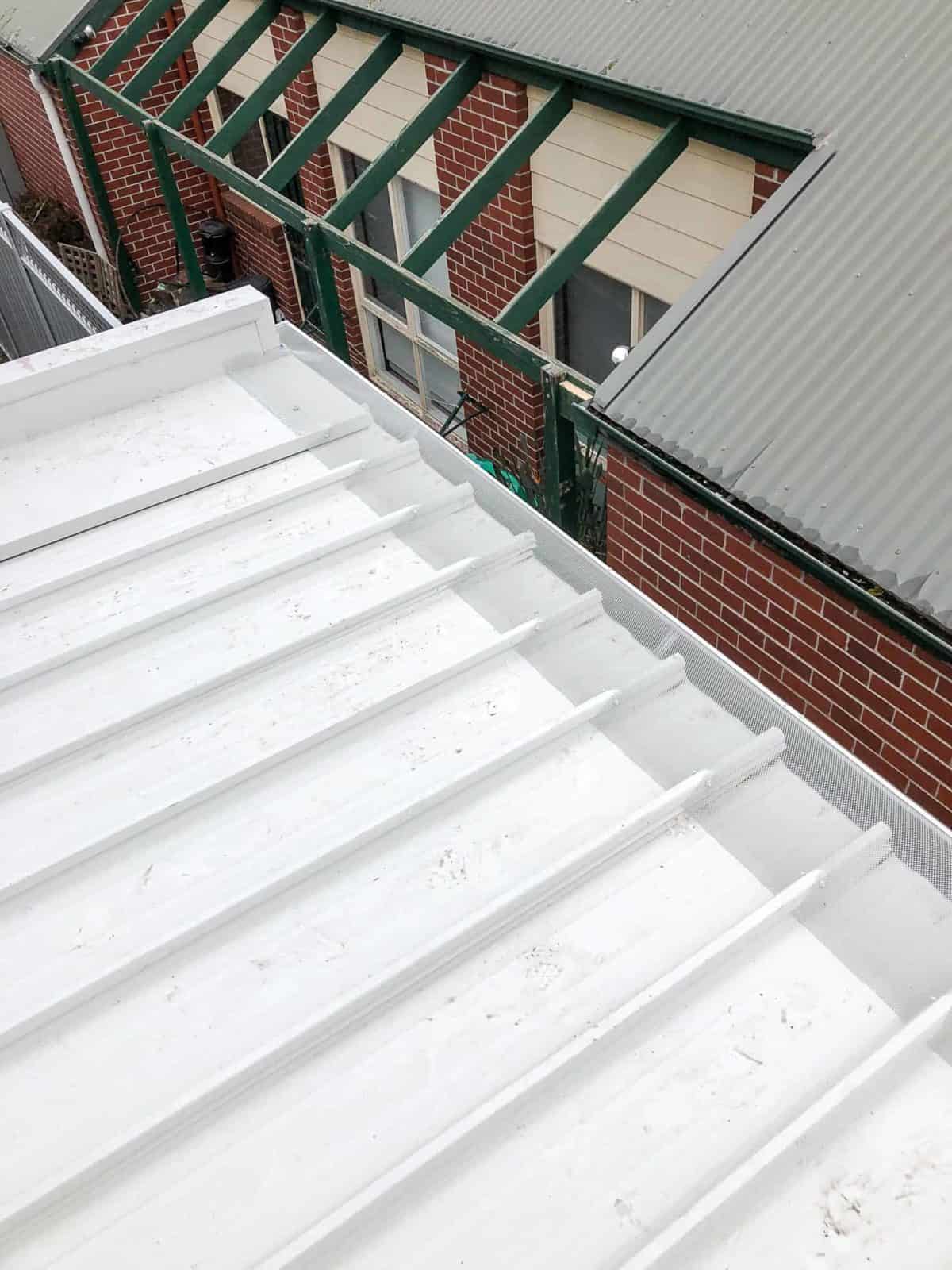 Trim deck roof with mesh gutter guard